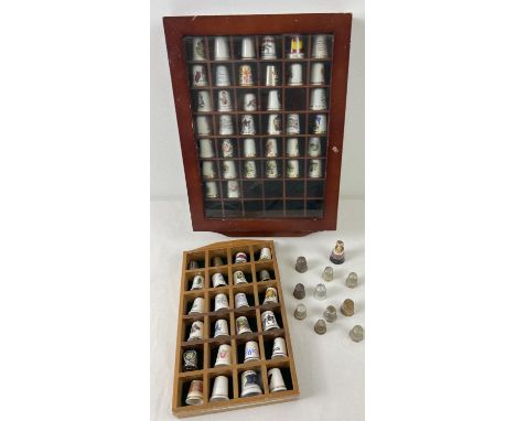 A collection of ceramic and metal thimbles in varying sizes and designs together with 2 small display cabinets. Thimbles incl