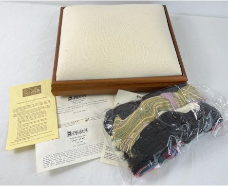 A boxed tapestry footstool kit. Complete with mahogany square shaped padded stool, Appletons tapestry wool and instructions. 