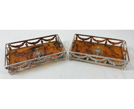 A pair of silver plated rectangular shaped coasters/trays with faux tortoiseshell bases, one a/f. Galleried sides with floral