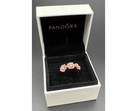 A 14ct rose gold plated and enamel 3 pink daisy dress ring by Pandora. Inside of band marked 'ale Met 56'. Ring size OÂ½ or 5