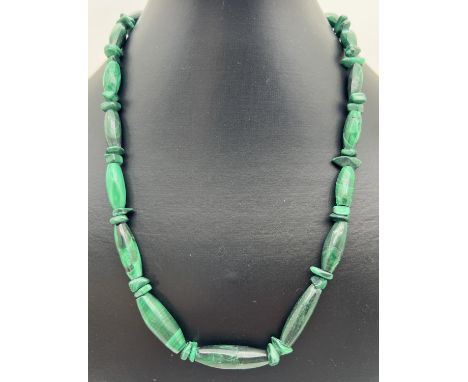 A 20 inch Malachite graduating oval bead and chip necklace with sterling silver spring ring clasp. 