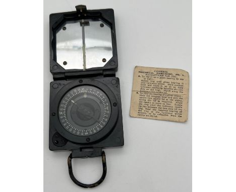 A Military Magnetic Marching Mk. 1 compass by T.G.Co, Ltd, Complete with instruction paper. Approx. 6.5cm x 6.5cm with carryi
