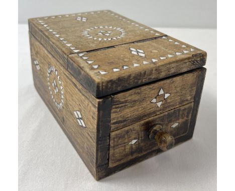 A vintage ethnic hardwood vanity box with inlaid mother of pearl detail to each side. Lift up folding lid to reveal a standin