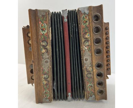 An antique Imperial Accordion by J.F. Kalbe. In need of attention/restoration. Deep maroon and gold patterned paper bellows w