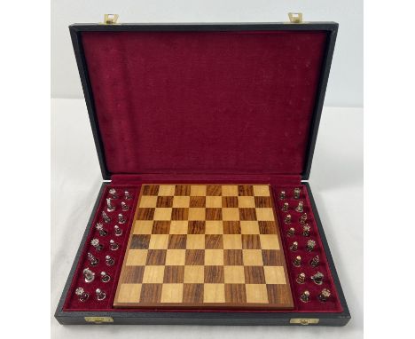 A cased silver chess set with silver and silver gilt playing pieces and a wooden chessboard. Each piece fully hallmarked, Lon