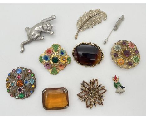 A collection of 10 vintage brooches and pins. To include faux pearl leaf design, stone set floral circular brooches, cat broo