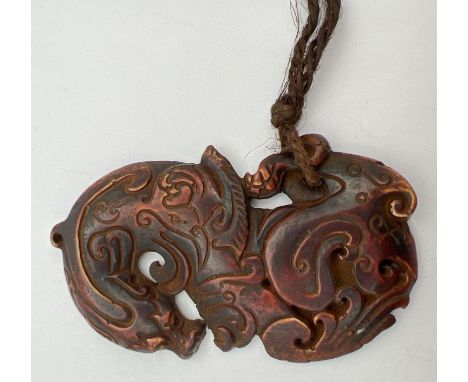 An oriental carved horn pendant modelled as a dragon. Approx. 9cm long. 