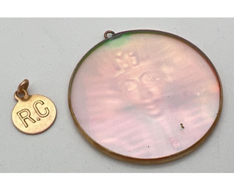 2 gold pendants. A large circular Pharaoh holographic glass pendant in a gold surround, together with a vintage circular pend