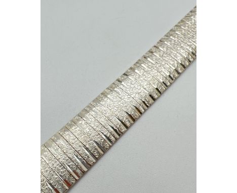 A 925 brushed silver design multi sectional bracelet with push clasp and safety clip. Silver marks to inside of clasp. Total 