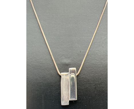 A modern design silver pendant necklace in brushed and plain silver, by Liga. Silver and makers marks to back of pendant. Sil