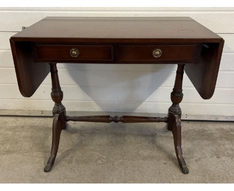 A modern dark wood, 2 drawer hall/console table with drop leaf ends. Brass claw feet &amp; loop handles and turned legs and s