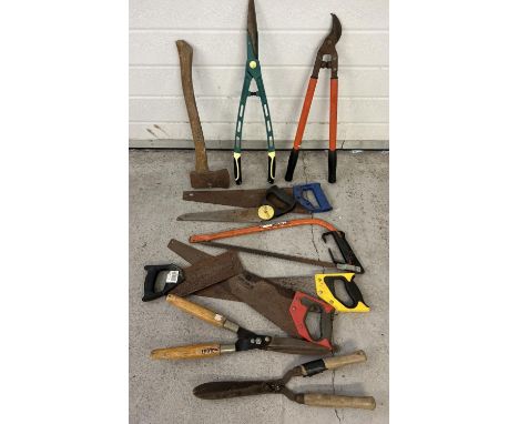 A box of assorted vintage and modern tools to include saws, shears and axe. 