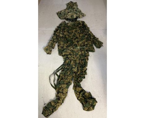 A 3 piece military woodland camouflage Ghillie suit. Comprising helmet and head cover, jacket/top and dungaree trousers. With