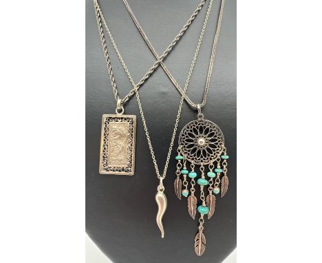 3 silver and white metal pendants on silver chains. A Dream catcher pendant with turquoise beads on an 18" fox tail chain; a 