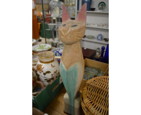 Small group of games, wicker basket and a carved wood model of a cat.