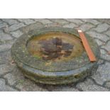 A circular bird bath top.