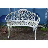 A small white painted cast metal garden bench.