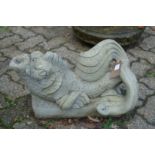 A pair of reconstituted stone dolphin fountains.