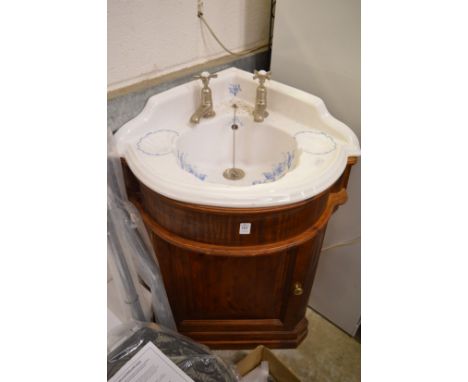 A Victorian style porcelain corner wash basin with mahogany vanity unit.