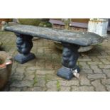 A reconstituted stone garden bench with squirrel supports.