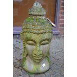 A reconstituted stone garden ornament modelled as the head of a Buddha.
