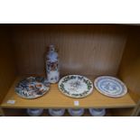 Decorative plates and an armorial wine flask.