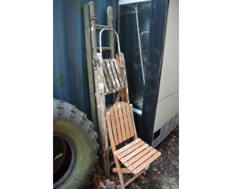 Folding chair and two folding step ladders.