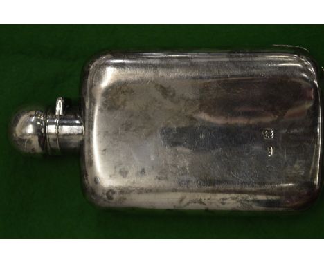 A silver hip flask.