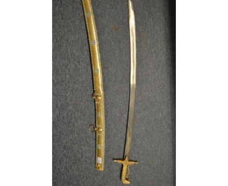 A highly ornate Eastern brass sword and scabbard, the gilded scabbard decorated with turquoise coloured stones together with 