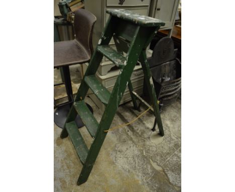 An old green painted wooden step ladder.