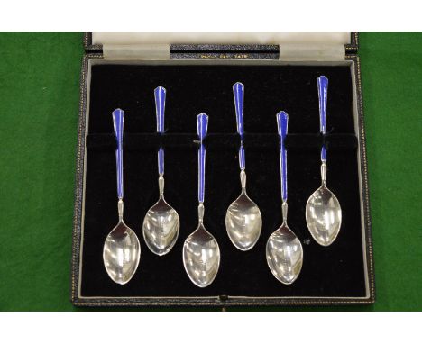 A cased set of six silver and enamel coffee spoons.