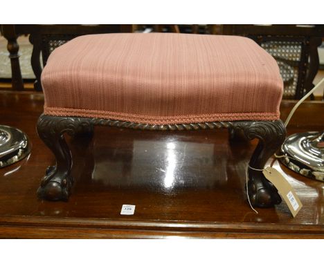 A small mahogany and upholstered stool on carved cabriole legs with claw and ball feet, labelled C Baker, Chippendale House, 