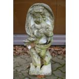 A reconstituted stone garden ornament modelled as a cherub.