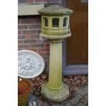 An unusual reconstituted stone pedestal bird table.