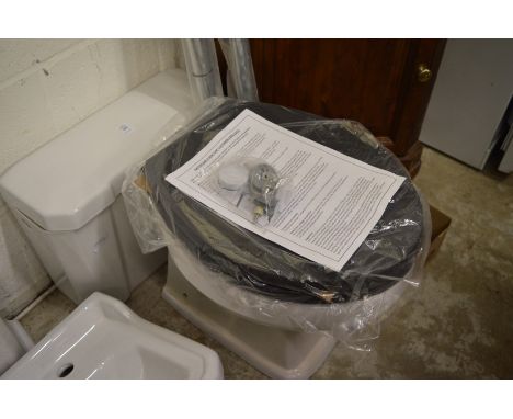 A Victorian style porcelain toilet basin with cistern, seat and accessories (unused).