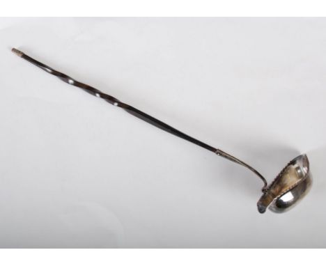 A 19th century Sheffield plate toddy ladle, the oval bowl set with an 1854 Four Pence coin, with two pouring lips, set to a t