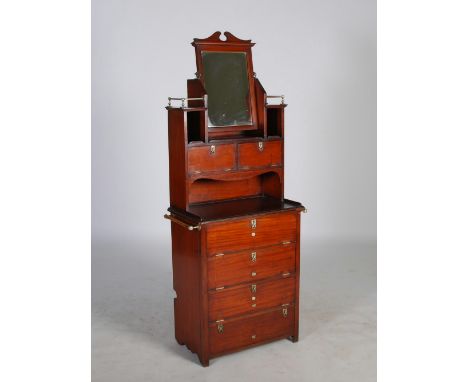 An early 20th century mahogany ships dressing table, fitted with a rectangular mirror plate flanked by open recesses above tw