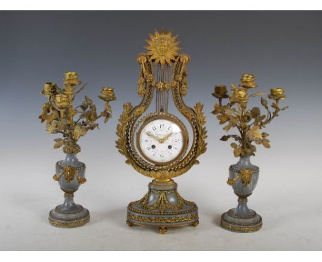 An early 20th century French gilt metal, grey alabaster and paste set clock garniture Tiffany & Co., the 4" circular convex d