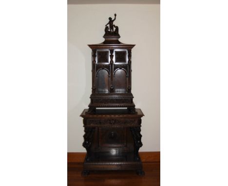 A 19th century Continental walnut console with arcaded top, the upper section of architectural form with figural and horse ca