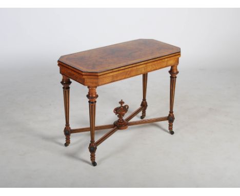 A Victorian walnut, boxwood lined and ebonised card table, the hinged and revolving rectangular top opening to a baize lined 