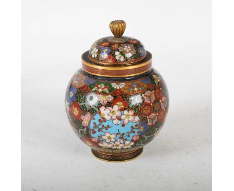 A Japanese black ground cloisonne jar and cover, Meiji Period, decorated with three circular shaped coloured panels enclosing