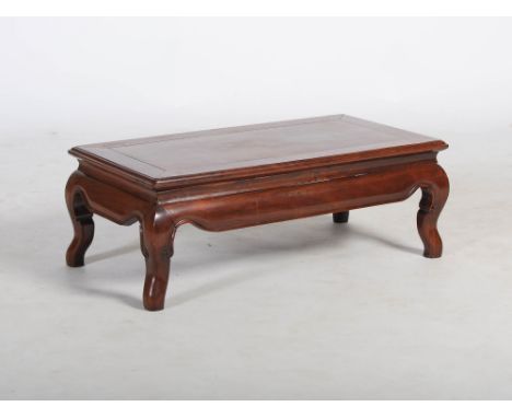 A Chinese dark wood low table, Late Qing Dynasty, the rectangular panelled top above a plain frieze, raised on four shaped su
