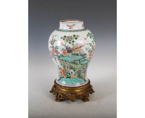 A Chinese porcelain ormolu mounted famille verte jar, Qing Dynasty, decorated with rockwork, birds, peony and fruit, mounted 