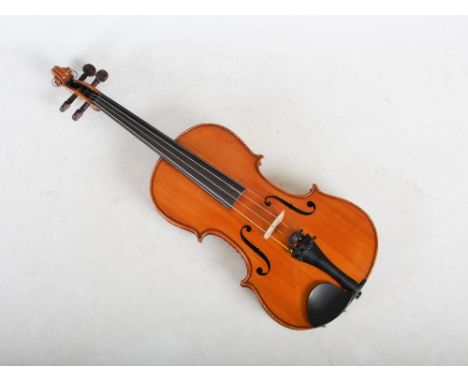 A late 19th/ early 20th century full sized violin, possibly German, Lowendal School, bearing paper label 'ANTONIUS STRADIVARI