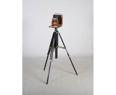 A Gandolfi, London, mahogany and brass mounted plate camera, leather case accessories and ebonised Gandolfi tripod, to includ