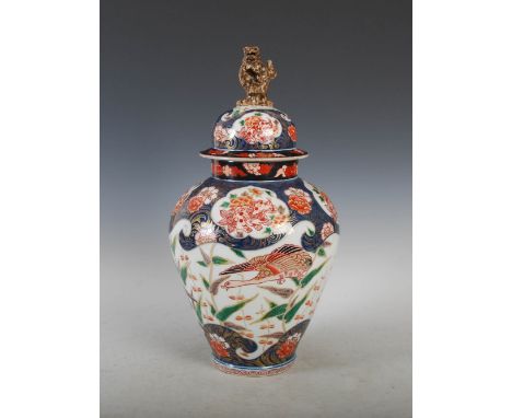 A Japanese Imari jar and cover, late 19th/ early 20th century, decorated with geese, peony and shishi, the domed cover with s