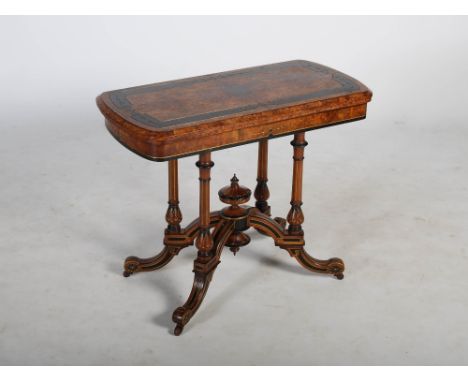 A Victorian walnut, ebonised and parcel gilt card table, the hinged revolving rectangular top opening to a claret baize lined