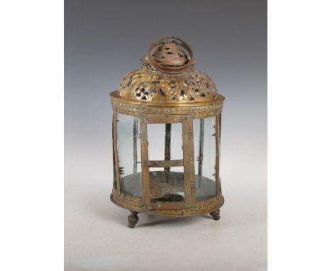 An 18th century Dutch brass lantern, with circular suspension ring above a pierced foliate and scroll dome top, the sides wit