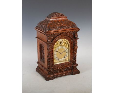 A late 19th century oak mantle clock, the brass dial with silvered chapter ring bearing Arabic and Roman numerals, with a sub