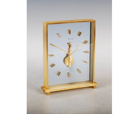 A Jaeger-Le Coultre mantle clock, the movement and batons suspended within tow glass plates, within brass case with brushed f